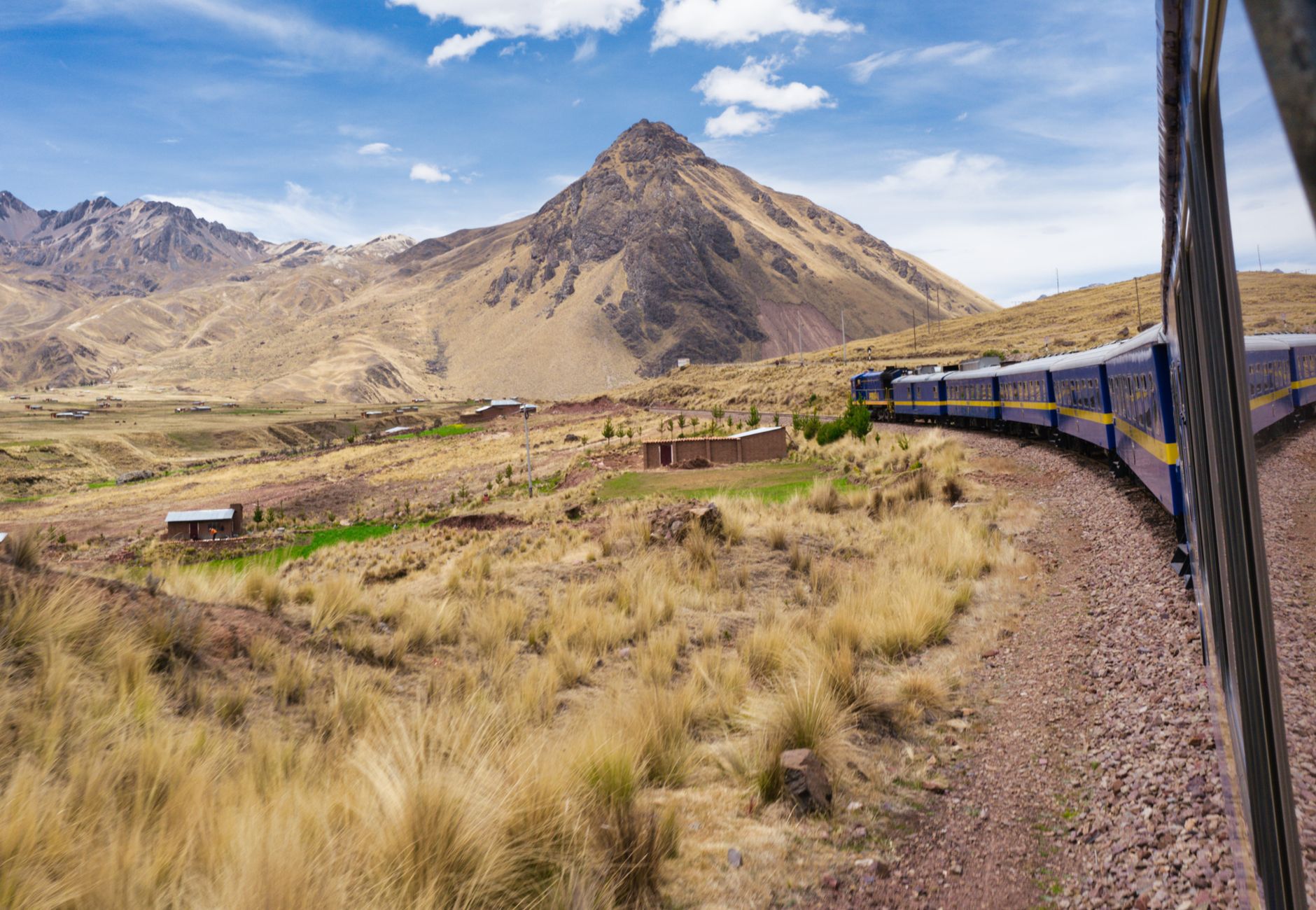Experience a breathtaking train journey through the picturesque landscape of the Andes in Peru.